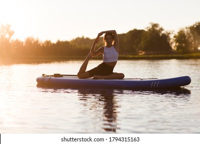 woman doing yoga on sup board. outdoor summer activity. Sup yoga. Social Distancing. copy space