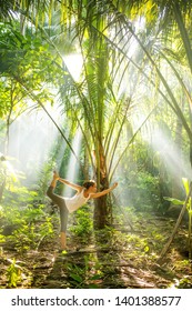 woman doing yoga outside in jungle - Shutterstock ID 1401388577