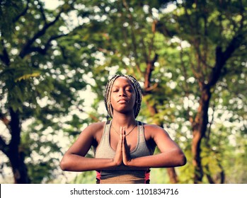 A woman doing yoga in the park - Powered by Shutterstock