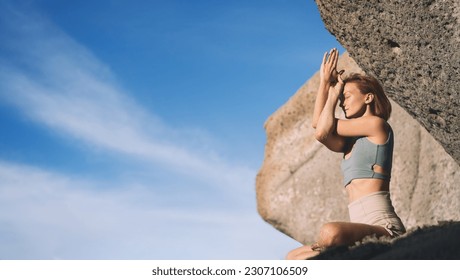 Woman doing yoga practice and meditating on the beach. Beautiful fit girl doing meditation and yoga breathing exercise on coastline of the ocean. Travel, Meditation, Yoga, Freedom, Healthy Lifestyles. - Powered by Shutterstock