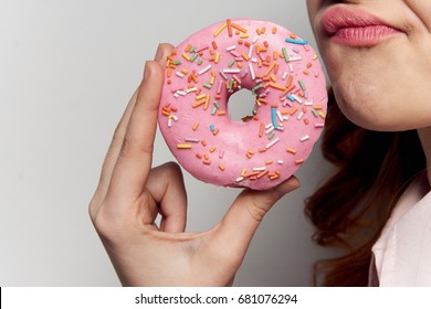 Woman with donut closeup sweetness delicious sweet tooth                               