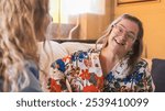 Woman with down syndrome is happily talking to her therapist during a session