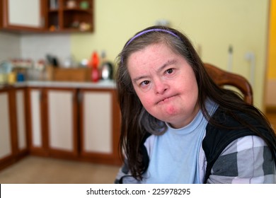 Woman With Down Syndrome In Kitchen 