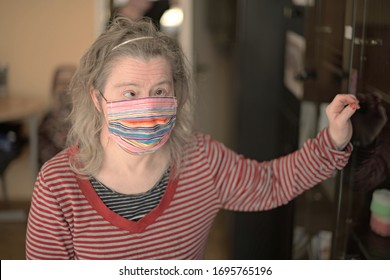 Woman With Down Syndrome With Respirator Mask In Kitchen