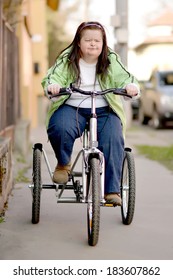 Woman With Down Syndrome Riding Tricycle