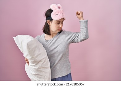 Woman With Down Syndrome Wearing Sleeping Mask Hugging Pillow Strong Person Showing Arm Muscle, Confident And Proud Of Power 