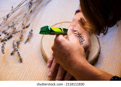 Woman Draw Mehendi On Her Hand. Mehendi Design.