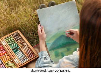 Woman drawing landscape and soft pastels outdoors  closeup