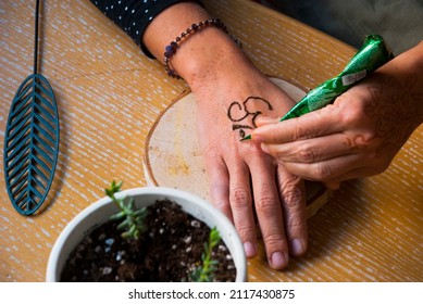 Woman Are Drawing Mehendi For Herself. Mehendi Design.