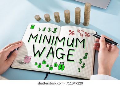 Woman Drawing Minimum Wage Words In Notepad