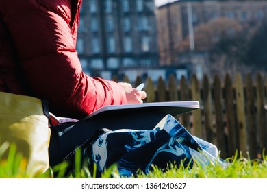 Woman Drawing On Sketchbook Outside In Edinburgh