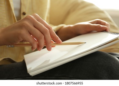 Woman drawing with pencil in notepad, closeup - Shutterstock ID 1807566955