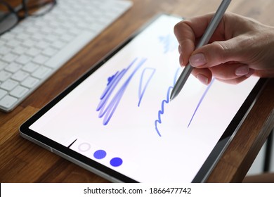 Woman drawing with stylus in digital tablet close-up. Drawing program concept