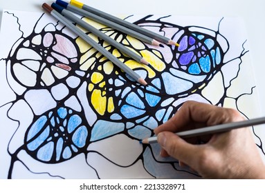 A woman draws neurographic drawing paper and color pencils  Neurographic art is an easy way to work and the subconscious mind through drawing  Taking care yourself