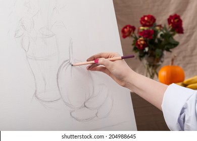 Woman draws still life white canvas