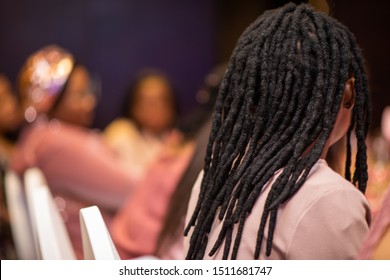 Woman with dreadlock hairstyle shot from behind