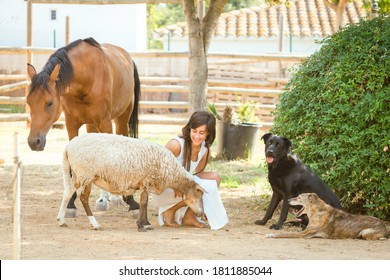 Woman with dreadlocks in white dress posing with her farm animals. - Powered by Shutterstock
