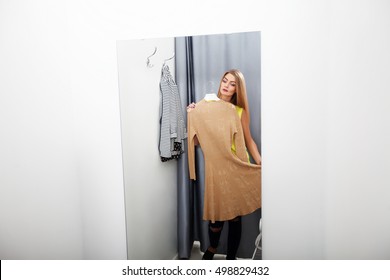 Woman with dress in the checkroom