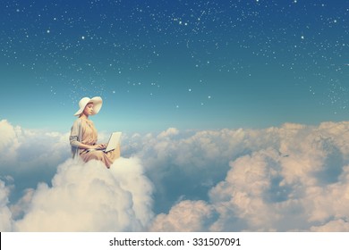 Woman in dress and hat sitting on cloud and working on laptop