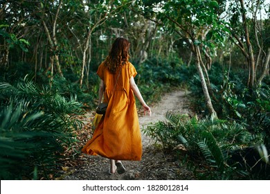 Woman in dress in jungle walk island trip