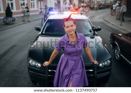 Woman in dress near police car