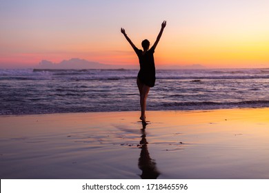 Woman in dress on beach at sunset. Caucasian model having fun on beach. Freedom sighn. Woman walks and runs on beach. Woman dancing on beach at sunset.