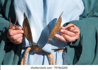 Woman dressed up like ancient celtic goddess devotee play cymbals during celtic pagan rituals