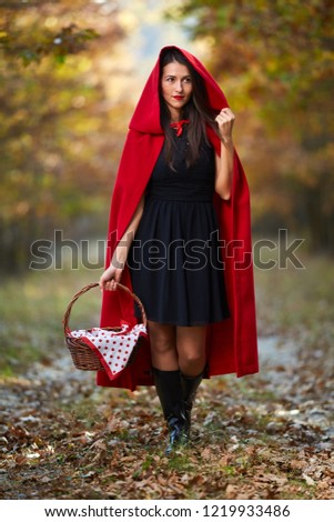 Woman dressed as Red Riding Hood in various postures in the forest