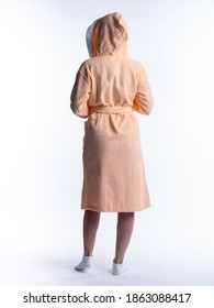 Woman In A Dressing Gown From The Back On An Isolated White Background. Shot In The Studio In Full Growth.