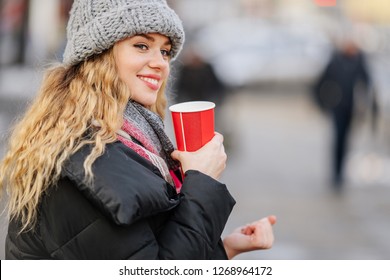 Woman Drink Her Hot Coffee While Walking On The Street. Portrait Of Stylish Smiling Woman In Winter Clothes Drinking Hot Coffee. Female Winter Style. - Image