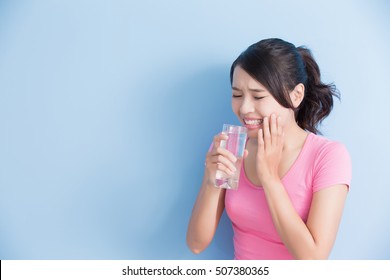 Woman Drink Water With Sensitive Teeth Isolated On Bluebackground