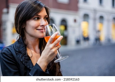 Woman drinking an aperitif in a bar