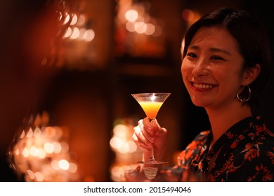 Woman drinking at the bar 
