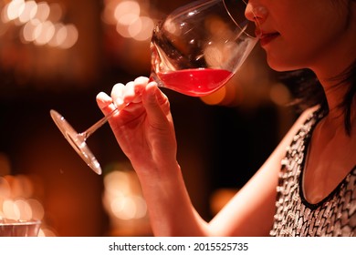 Woman drinking at the bar 
