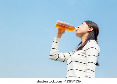 Woman Drinking A Bottle Of Iced Tea