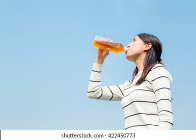 Woman Drinking Bottle Of Tea