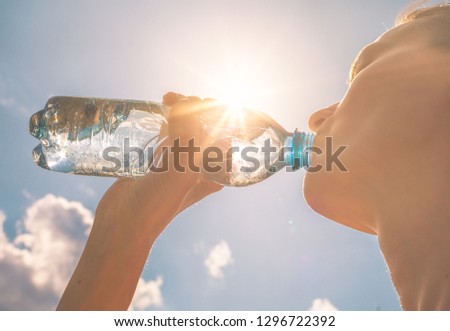 Woman drinking bottle of water. 