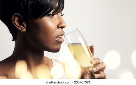 woman drinking from champagne glass. bokeh below