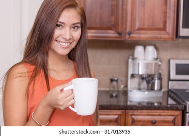 Woman Drinking Coffee In Her Nice Kitchen