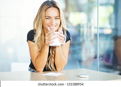 Woman Drinking Coffee In The Morning At Restaurant (soft Focus On Eyes)