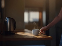 Woman Is Drinking Coffee , Morning Routine. Tiny House. First Property. Small Apartment Interior Design. Minimalism. Moving In. Living Alone. Charming Trailer House With The Morning Sun