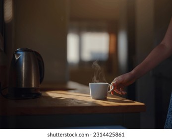 Woman is drinking coffee , morning routine. Tiny house. First property. Small apartment interior design. Minimalism. Moving in. Living alone. Charming trailer house with the morning sun - Shutterstock ID 2314425861