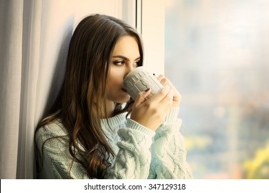 Woman Drinking Coffee Near Window In The Room