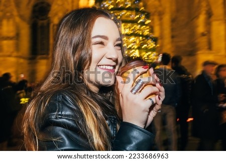 Woman drinking coffee in the night on street