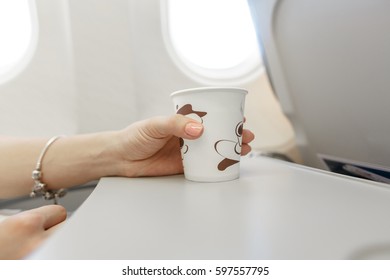 Woman  Drinking Coffee On Airplane.