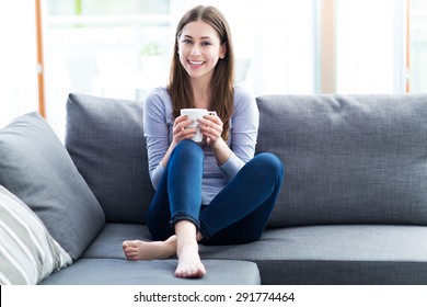 Woman Drinking Coffee On Sofa
