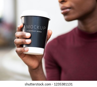 Woman drinking coffee out of a paper cup mockup