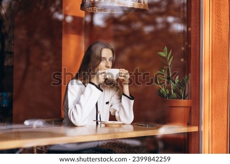 Similar – Young woman looking at cellphone