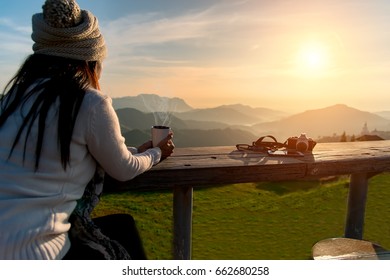 Woman drinking coffee in sun sitting outdoor in sunshine light enjoying her morning coffee, vintage, soft and select focus 