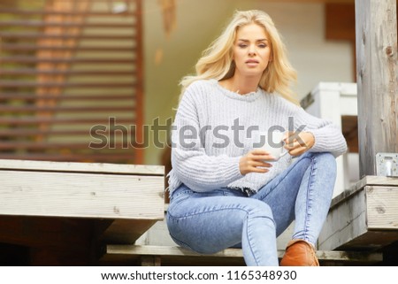Woman drinking coffee at terrace on a sunny morning